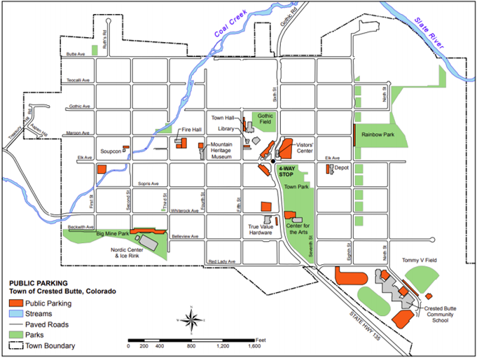 Map of Crested Butte, Colorado, showing public parking areas in orange near landmarks like Town Hall, Visitor Center, and Crested Butte Community School. Parks are marked in green, including Rainbow Park, Town Park, and Big Mine Park. Streams, paved roads, and the town boundary are also shown.